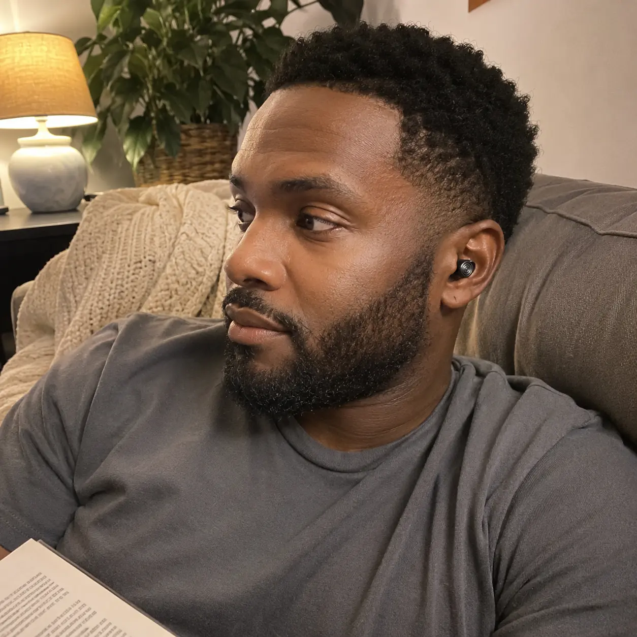 Customer relaxing with a Driftwell earplug while reading