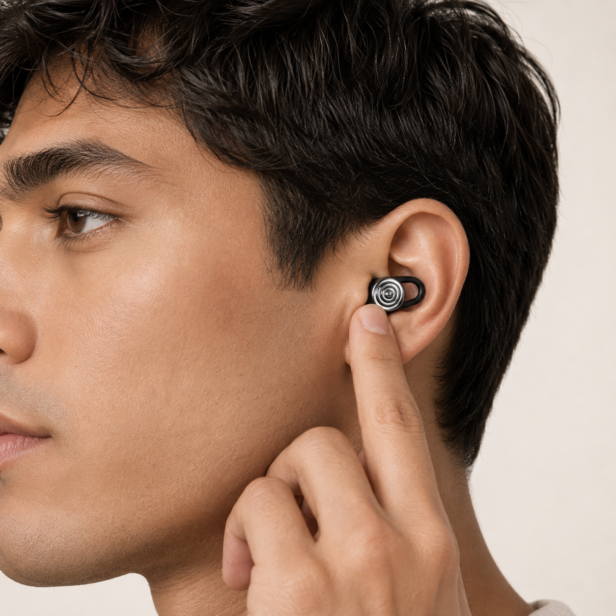 Man inserting a Driftwell earplug into his ear and holding it in place