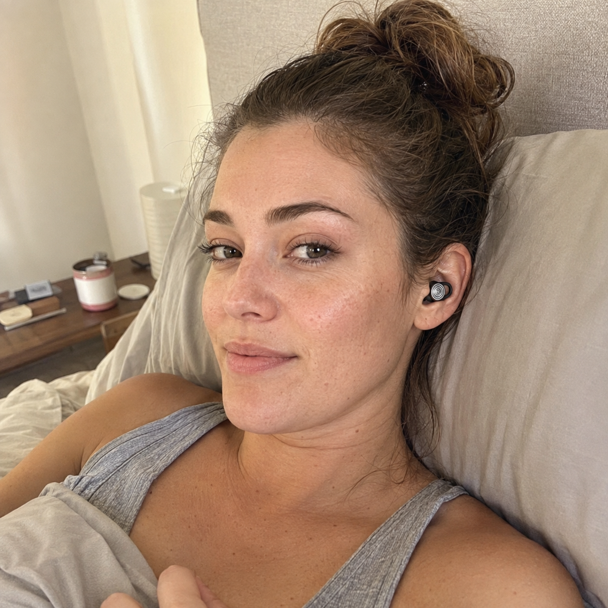 Customer wearing Driftwell earplugs while resting in bed